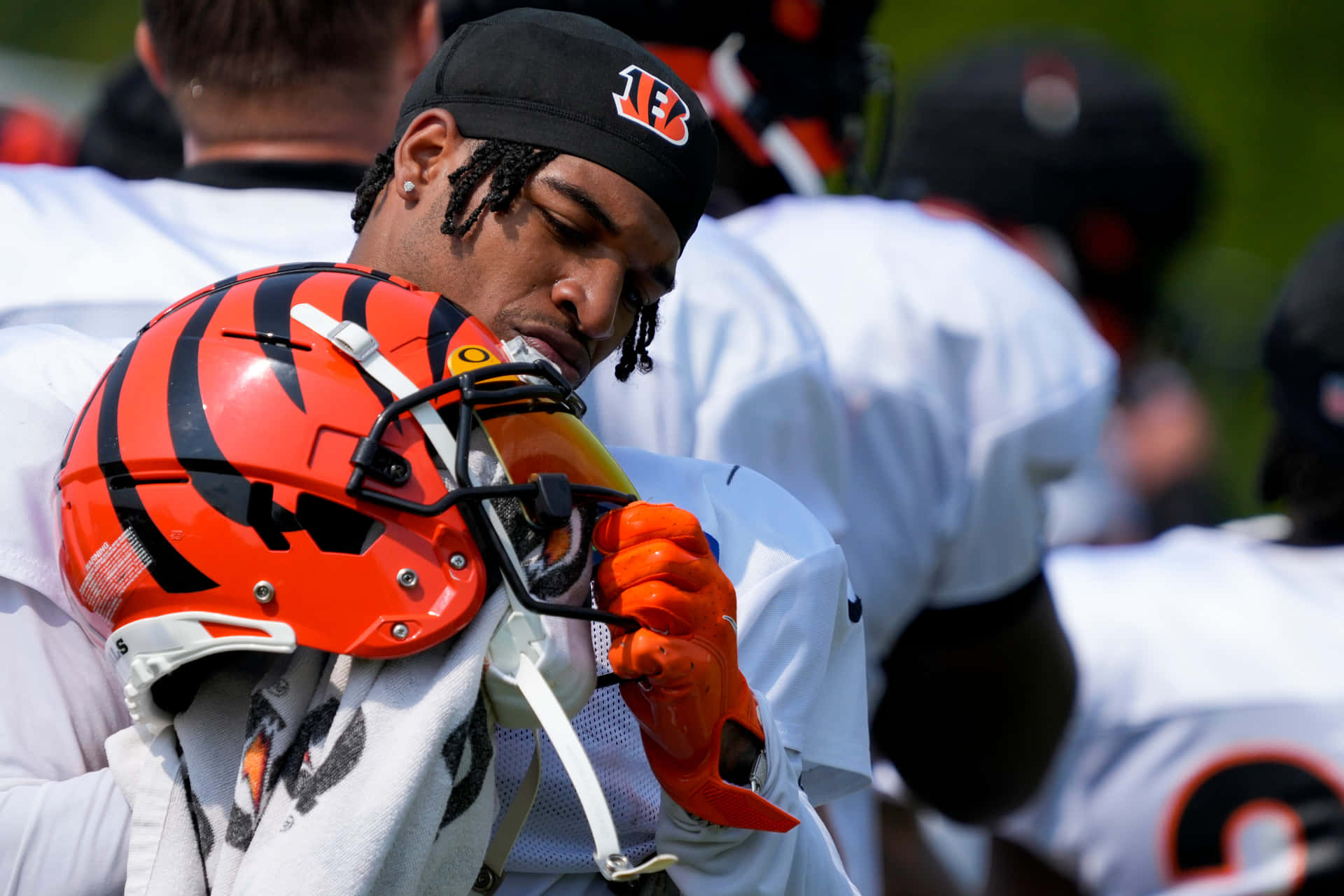 Focused Football Player Adjusting Helmet Wallpaper