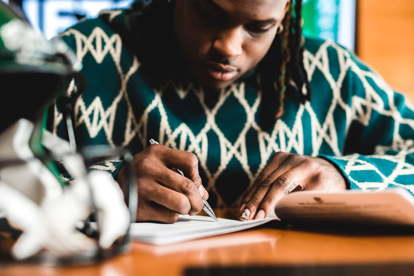 Focused Man Writingin Notebook Wallpaper
