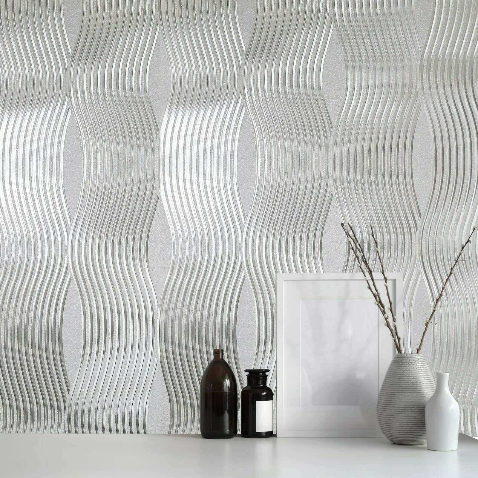 Foil Texture Background — A modern silver wave-patterned wallpaper with glossy ridges, accented by minimalist decor including vases and a framed picture.