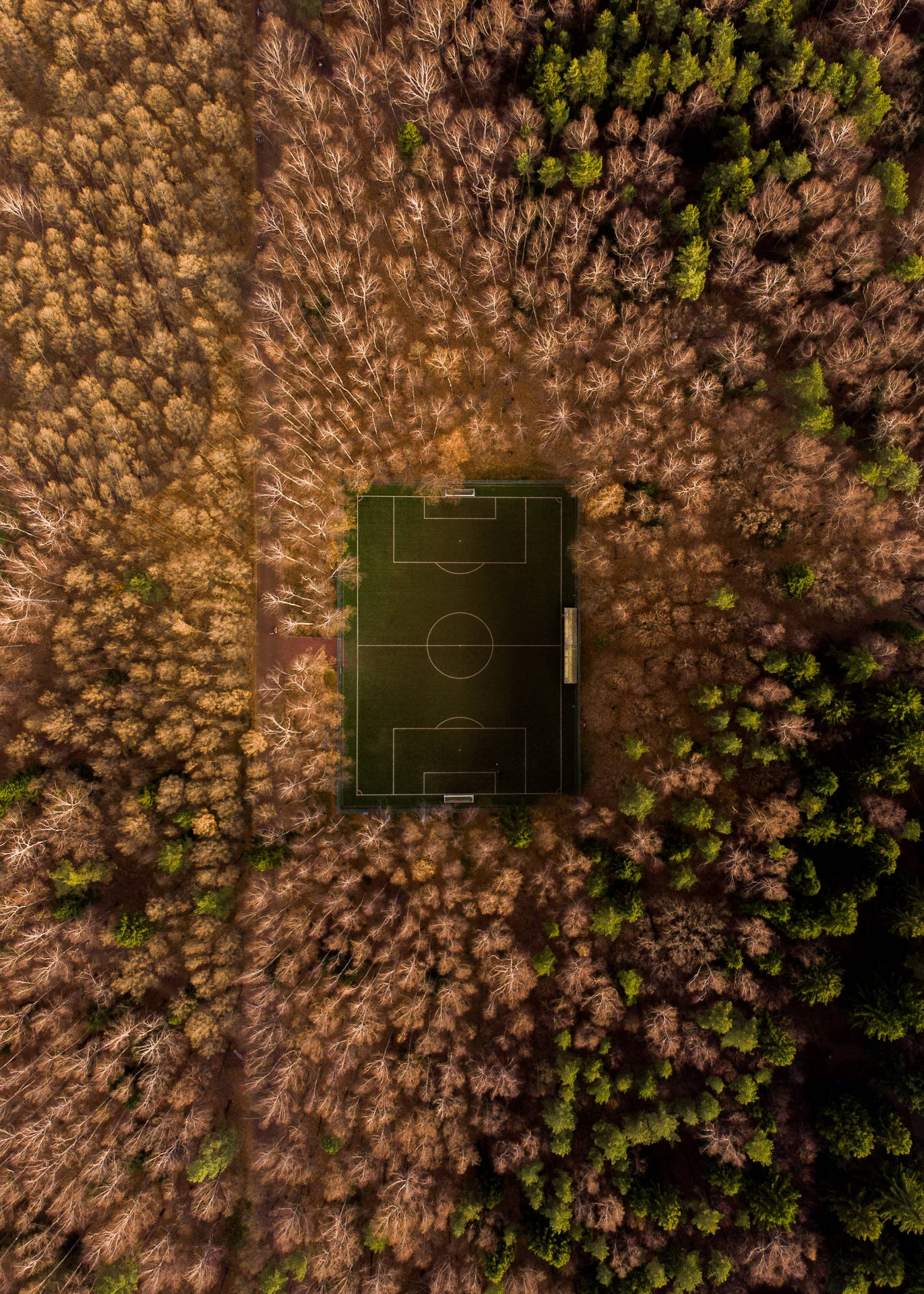 A Bird's Eye View of a Football Field on a Sunny Day Wallpaper