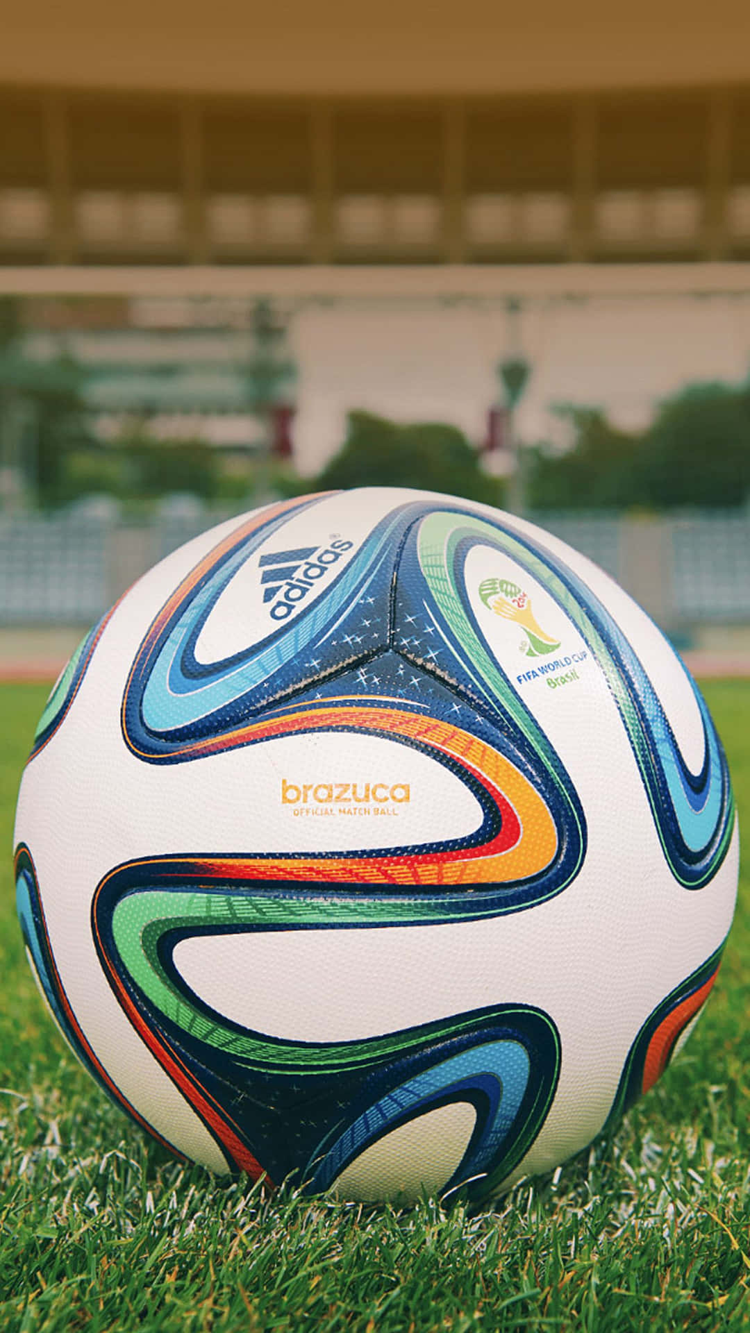 Football Galaxy Ball On A Grassy Ground Wallpaper