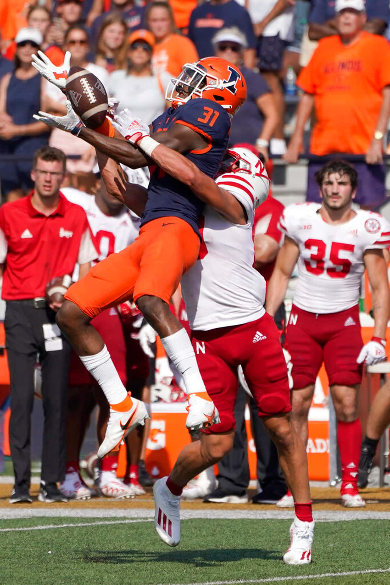 Football Player Catching Ball During Game Wallpaper