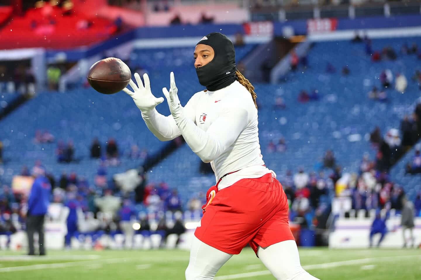Football Player Catching Ball During Warmup Wallpaper