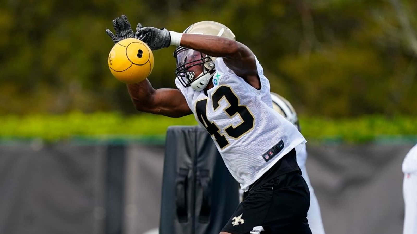 Football Player Catching Smiley Ball Drill Wallpaper