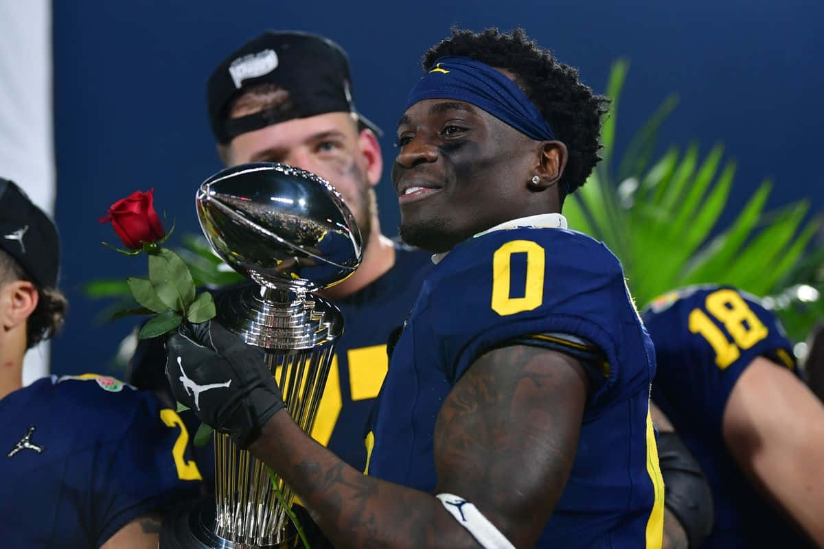 Football Player Celebratingwith Trophyand Rose Wallpaper