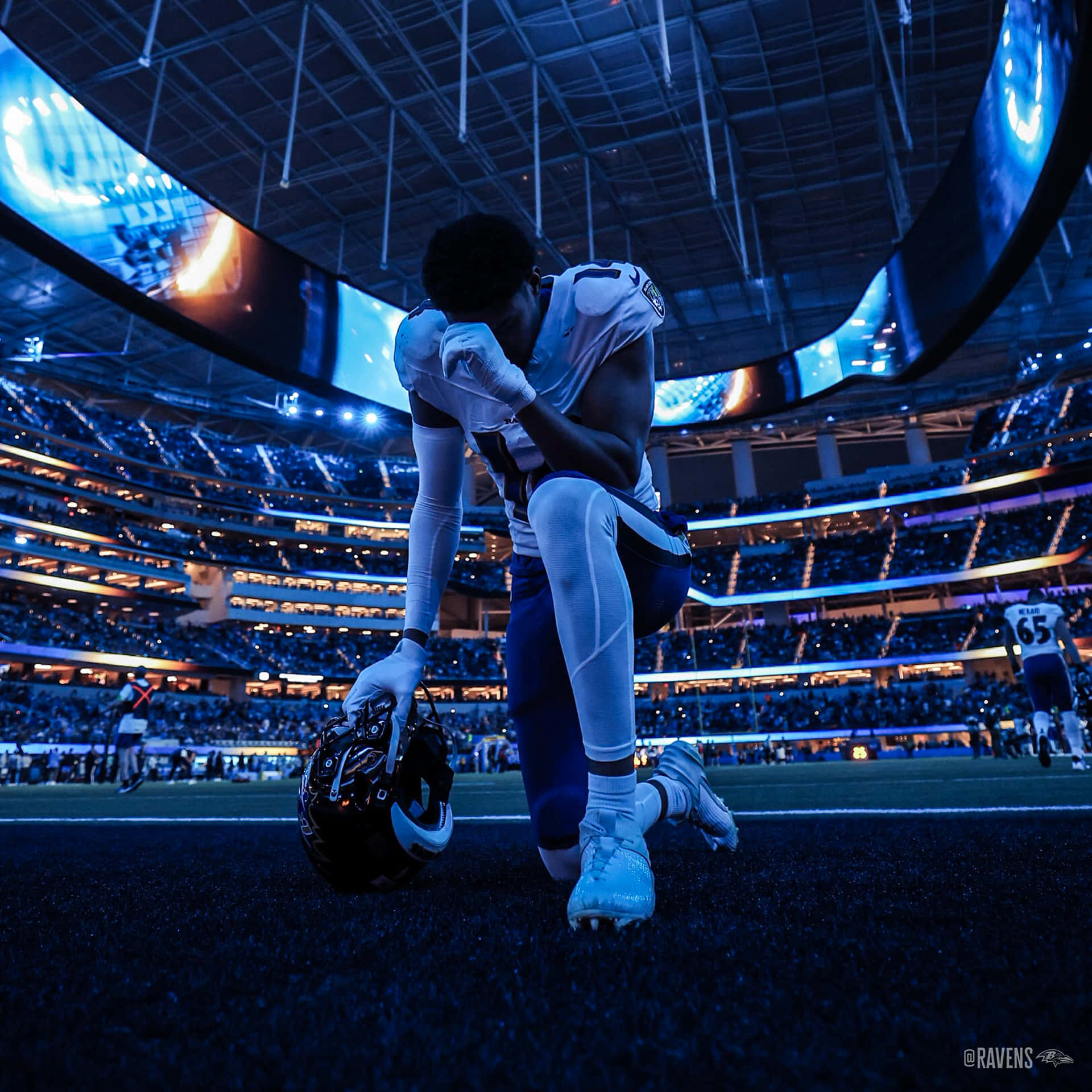 Football Player Reflective Moment Stadium Wallpaper