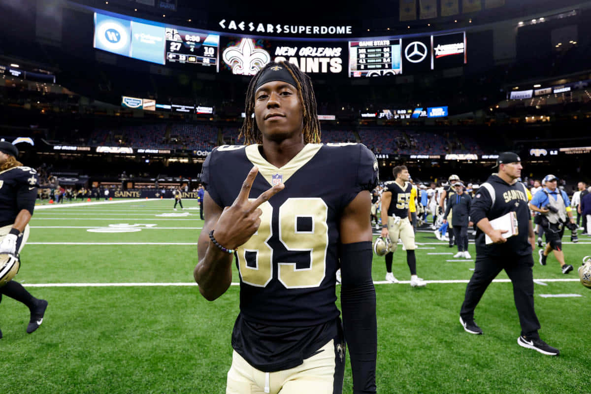 Football_ Player_ Victory_ Pose_at_ Superdome Wallpaper