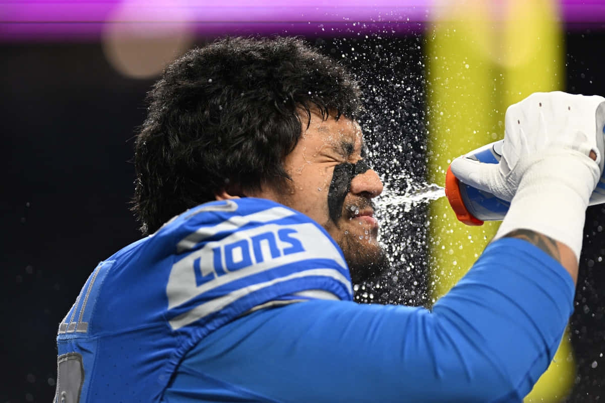 Football Player Water Splash During Game Wallpaper