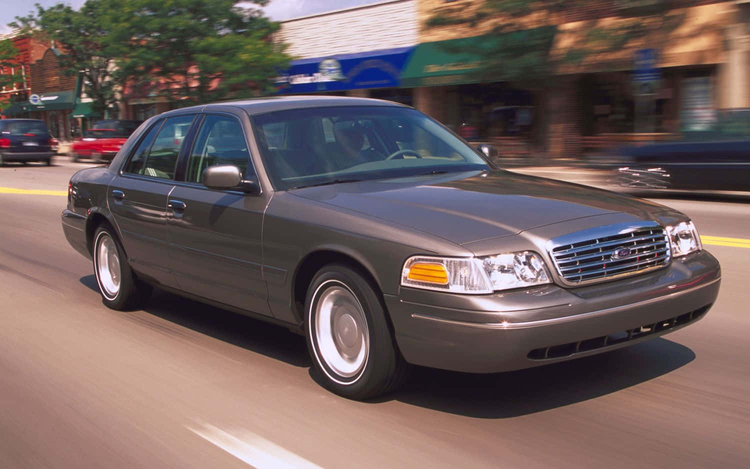 Powerful Ford Crown Victoria cruising on the road Wallpaper
