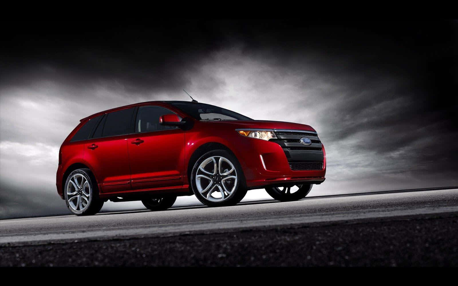 Sleek Ford Edge driving on a scenic road Wallpaper