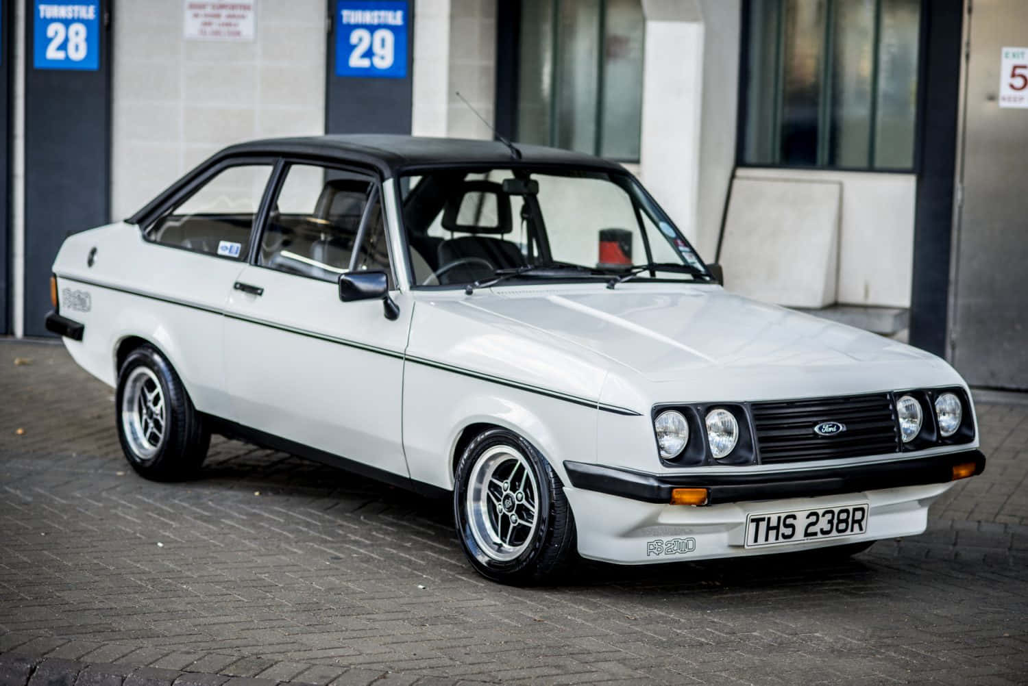 Classic Ford Escort showcased at an automobile event Wallpaper