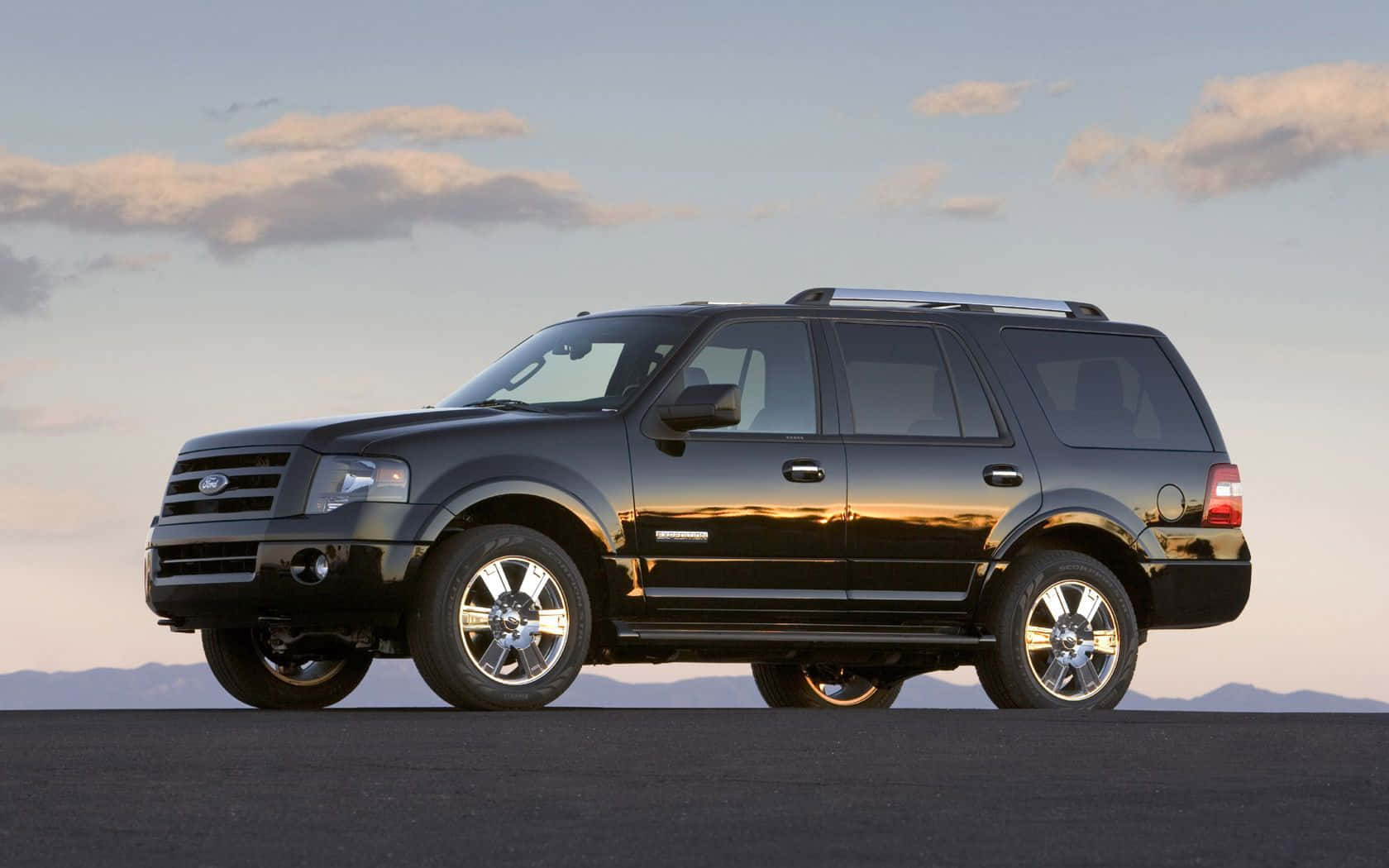 Ford Expedition Driving Through a Scenic Landscape Wallpaper
