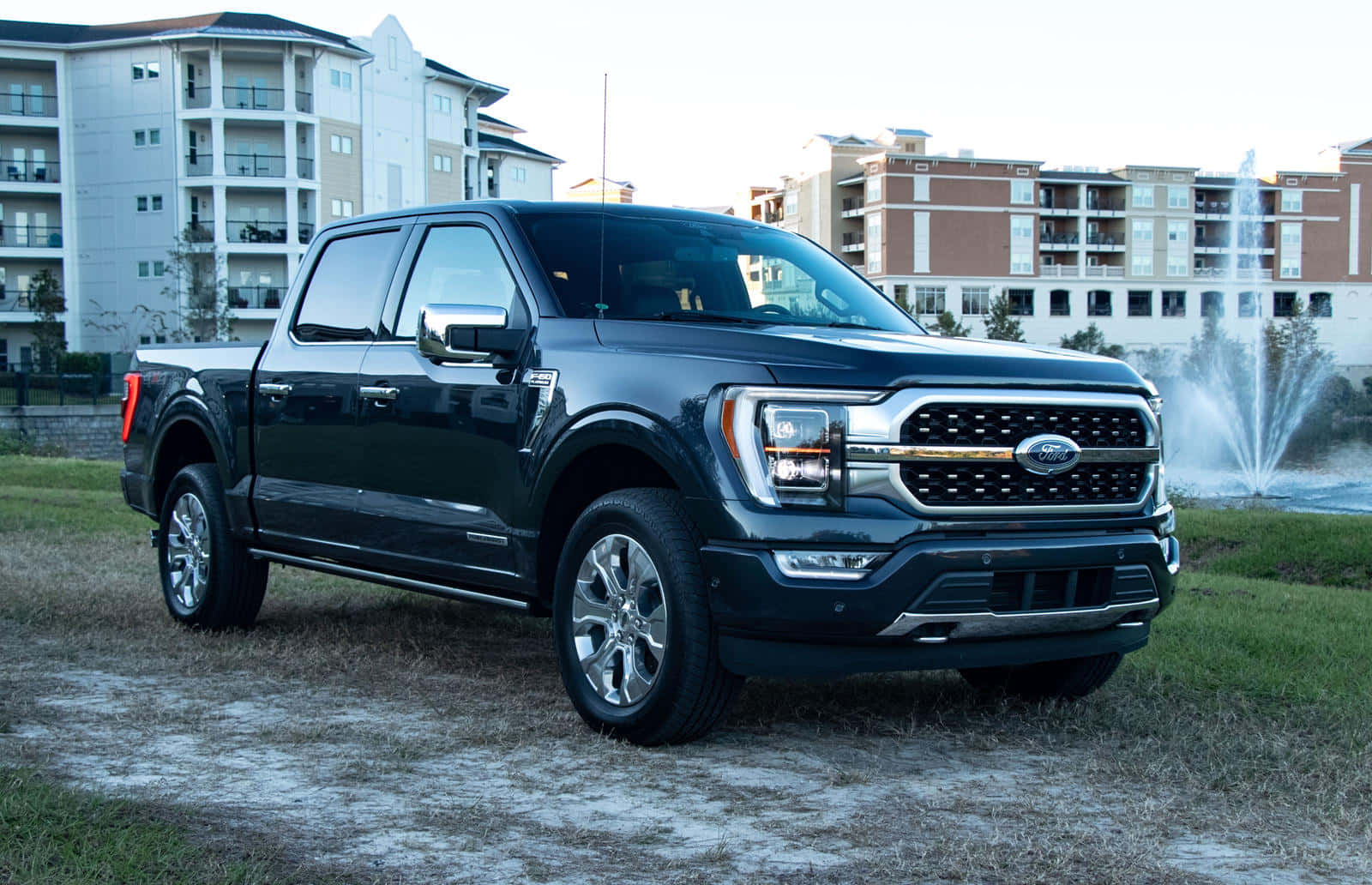 The 2019 Ford F - 150 Is Parked In Front Of A Fountain Wallpaper