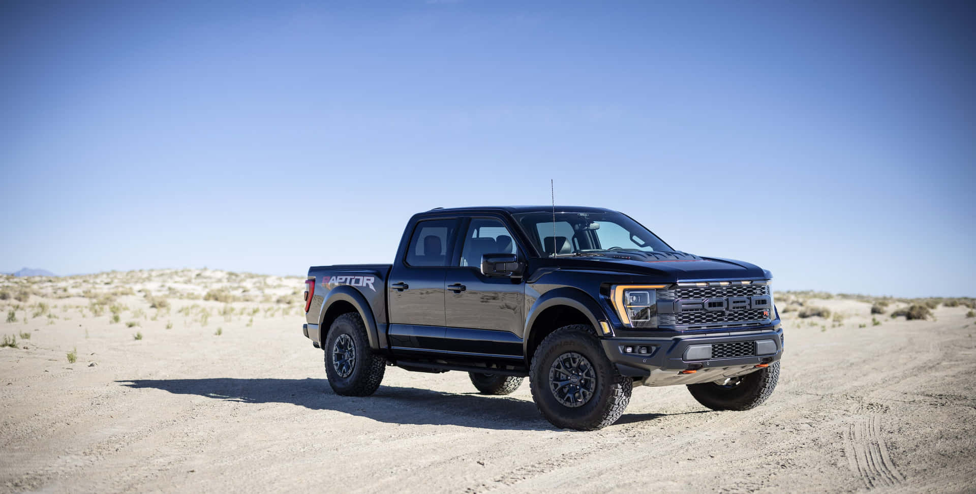 The Black Ford F - 150 Rk Cab Is Parked In The Desert Wallpaper