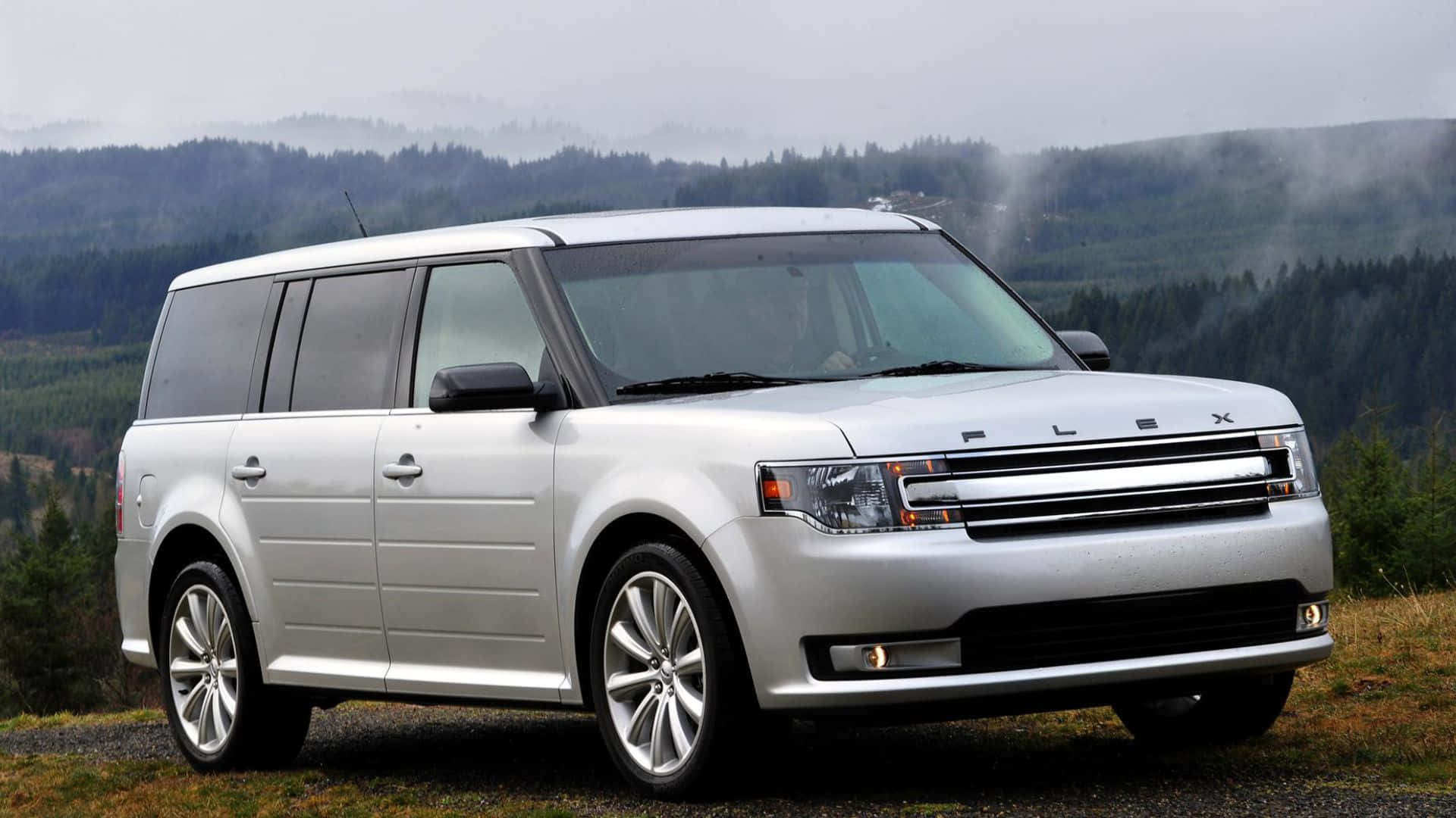 A Sleek and Modern Ford Flex on Scenic Mountain Road Wallpaper