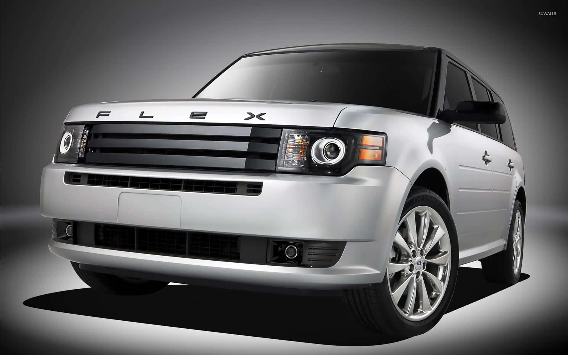 A sleek silver Ford Flex parked by the waterfront Wallpaper