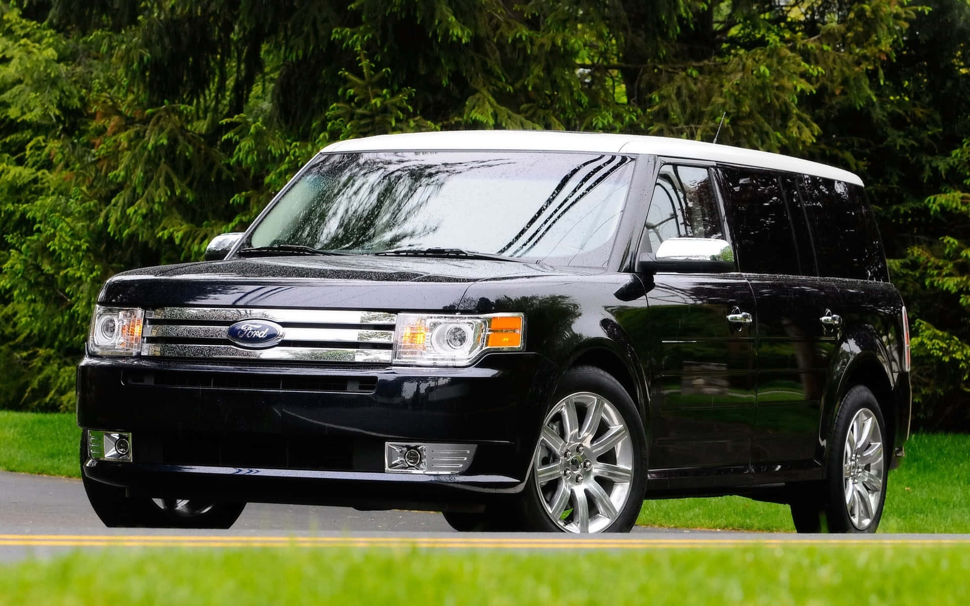 Sleek Ford Flex cruising on a scenic road Wallpaper