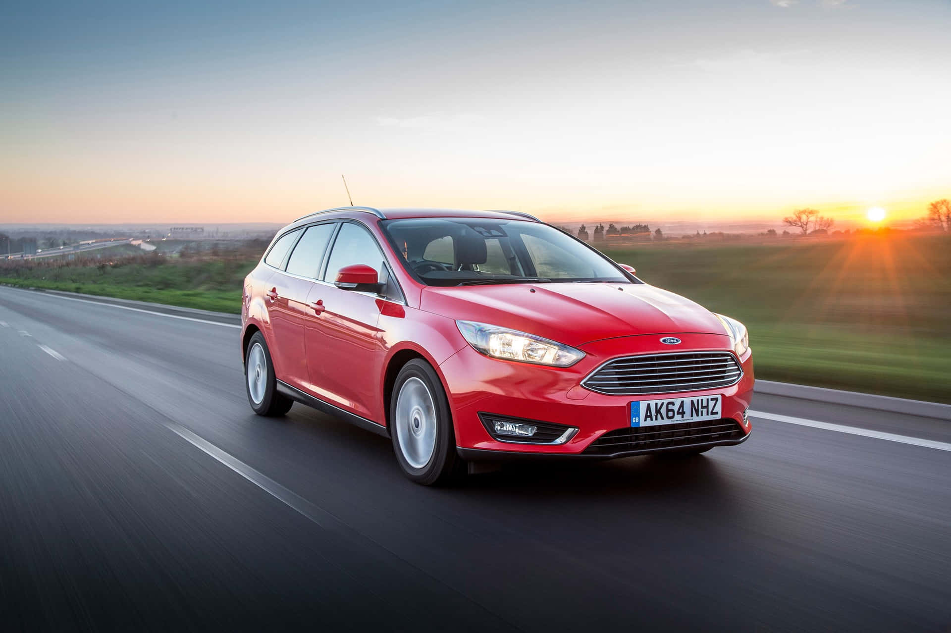 Sleek Ford Focus in motion on a stunning road Wallpaper