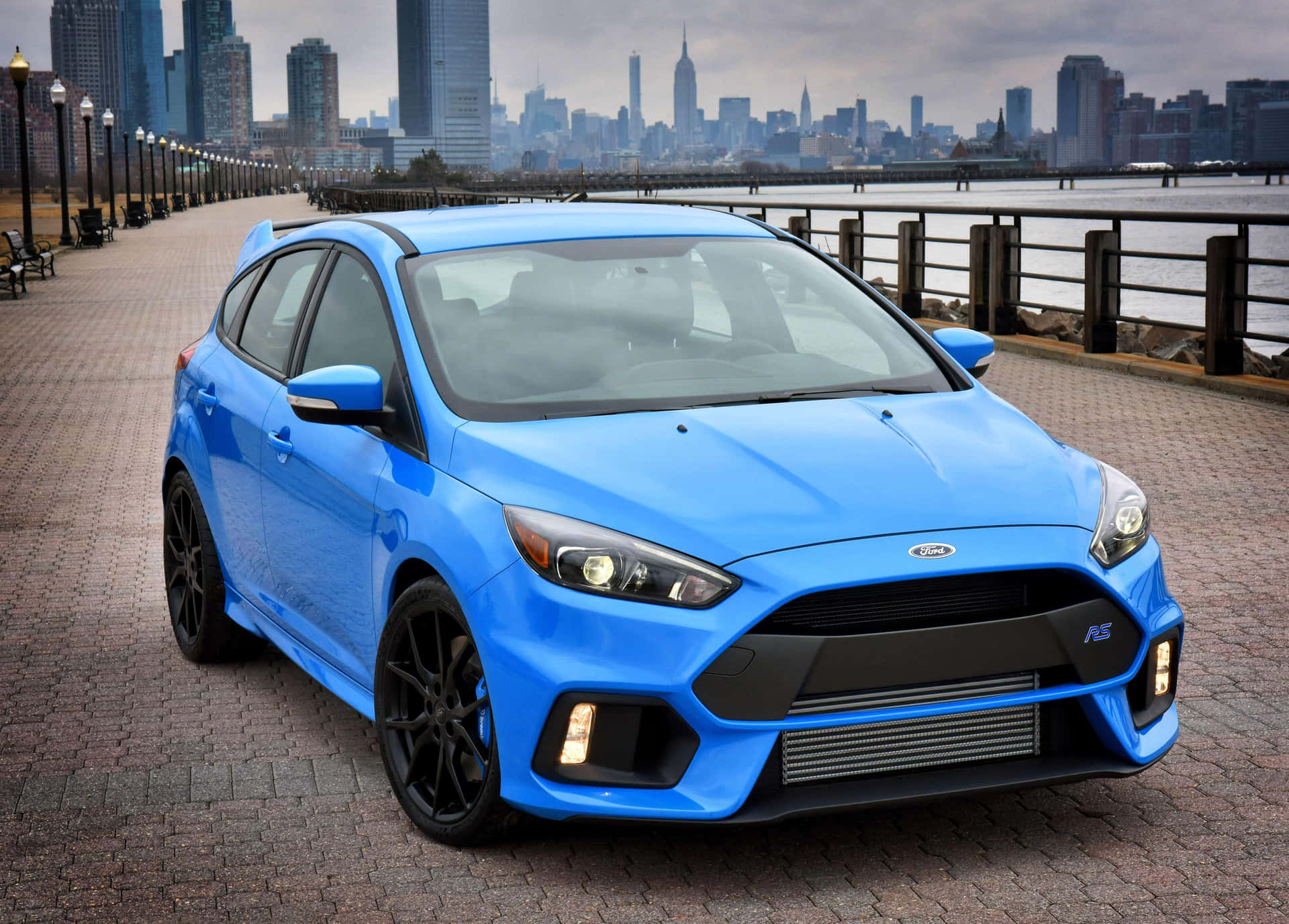 Sleek Red Ford Focus Cruising on a Scenic Road Wallpaper