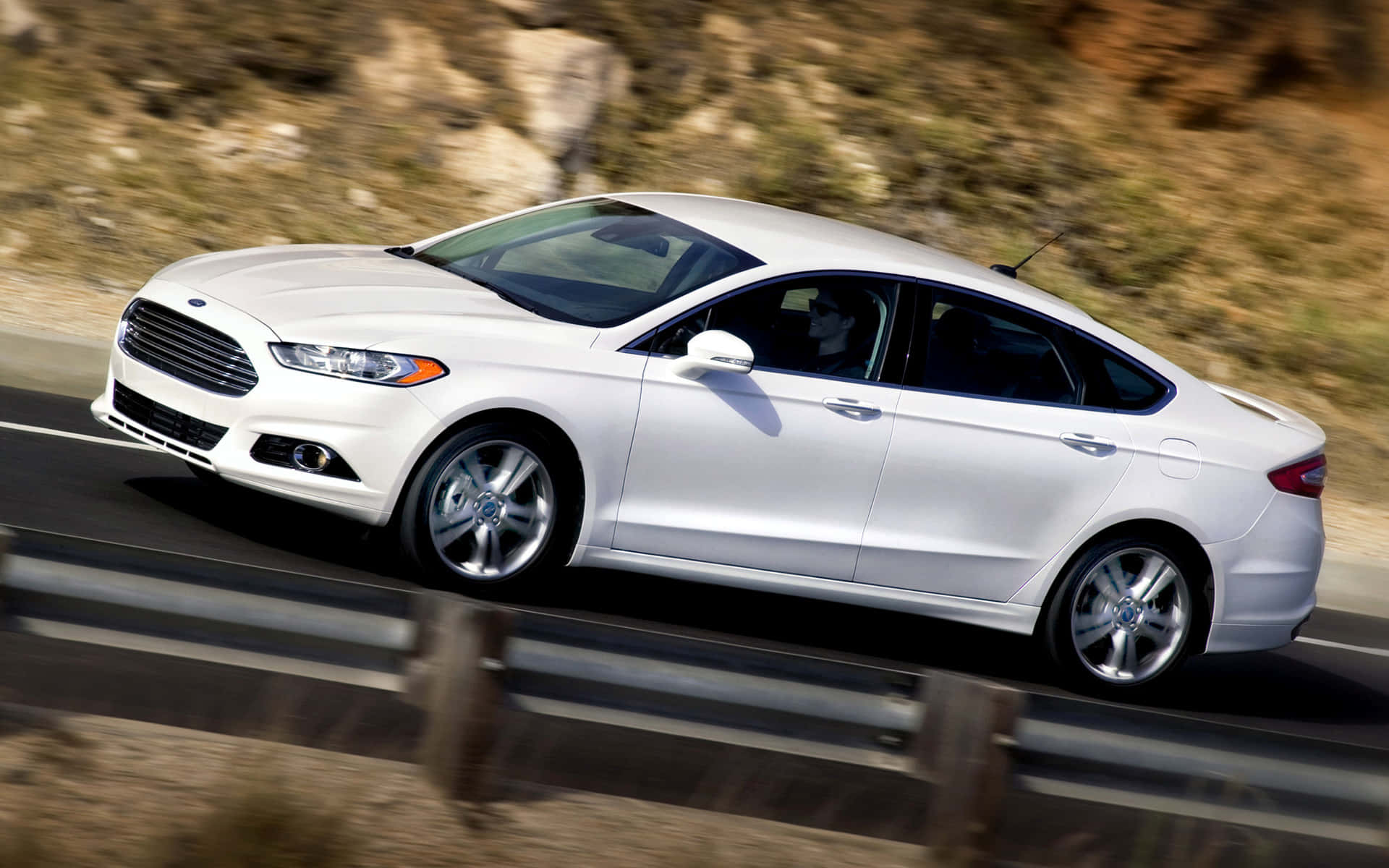 Sleek and Stylish Ford Fusion on a Beautiful Scenic Road Wallpaper
