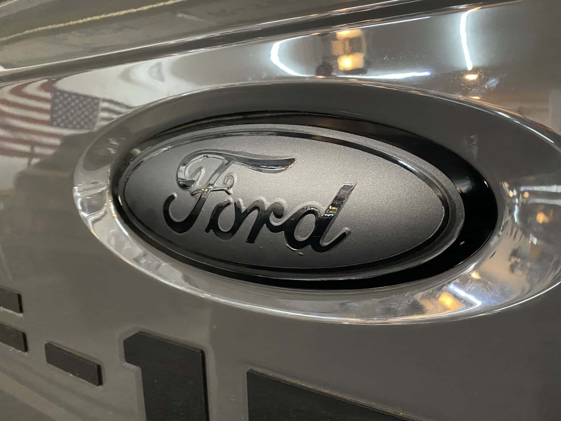The iconic Ford logo on a dark background Wallpaper