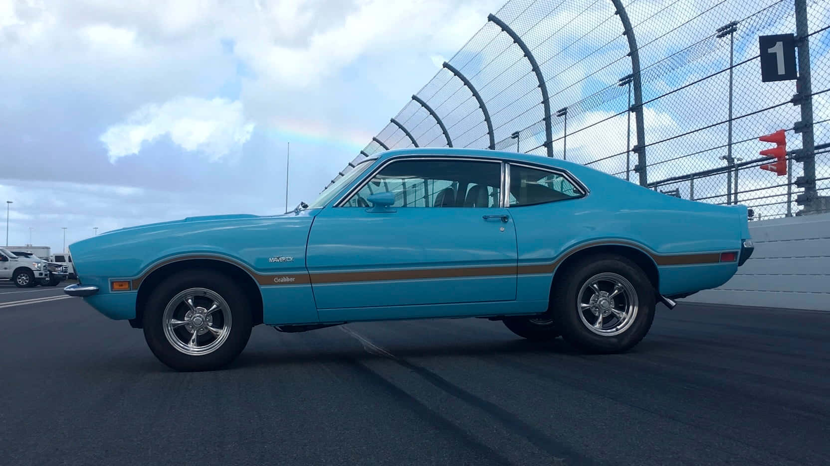 A Blue Muscle Car Is Parked On A Race Track