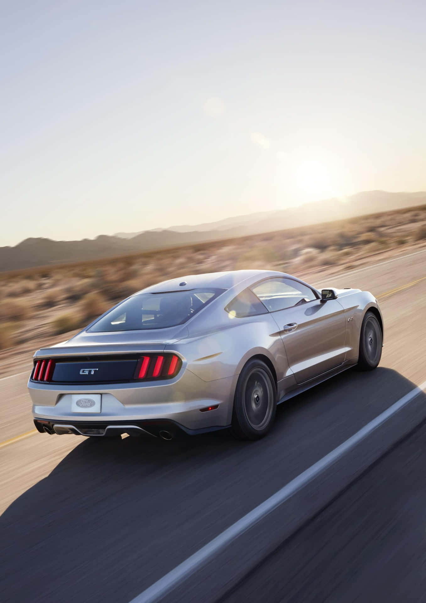 Caption: Red Ford Mustang California Special in Scenic Mountain Setting Wallpaper