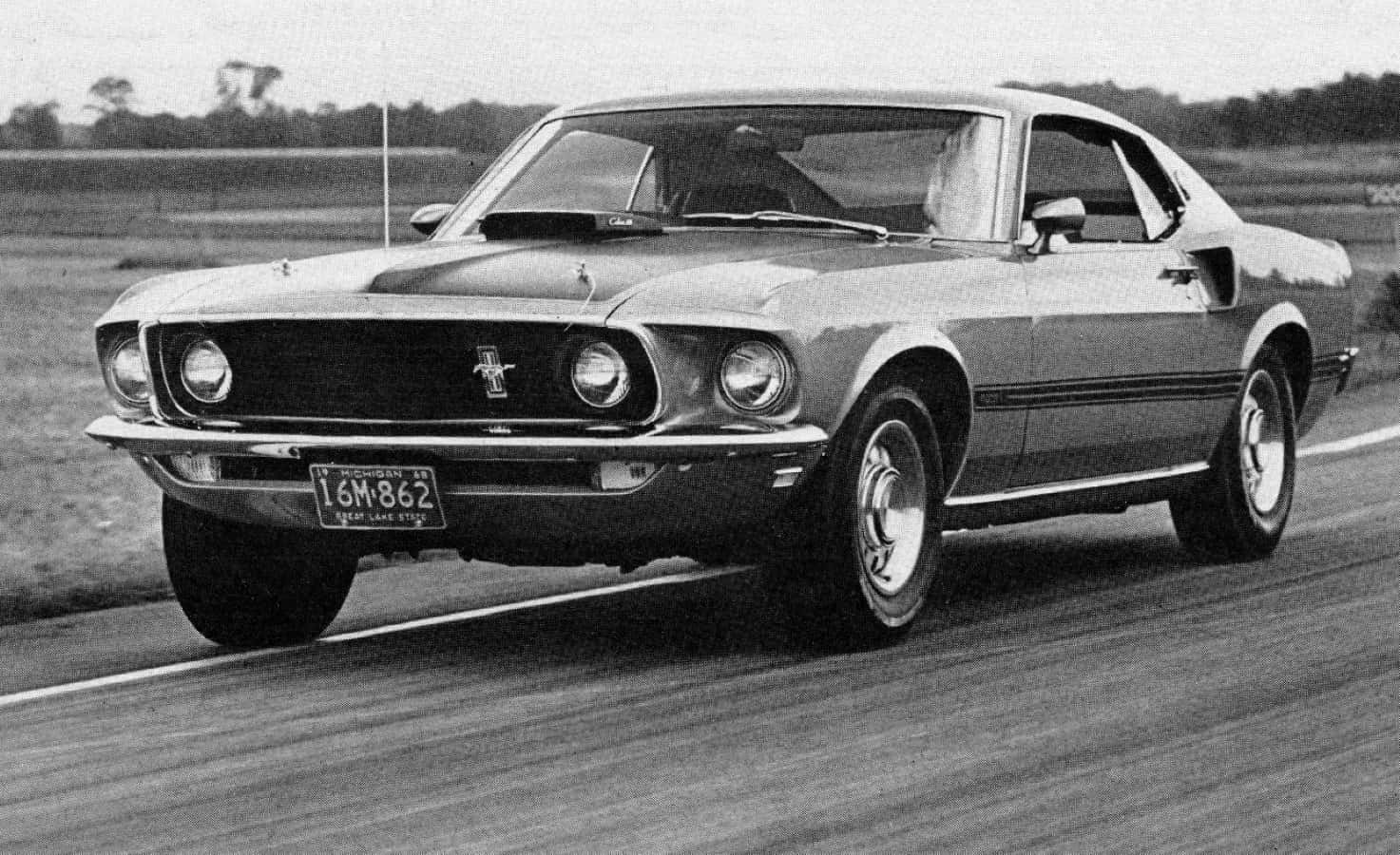Caption: Ford Mustang Mach 1 showcasing speed and style Wallpaper