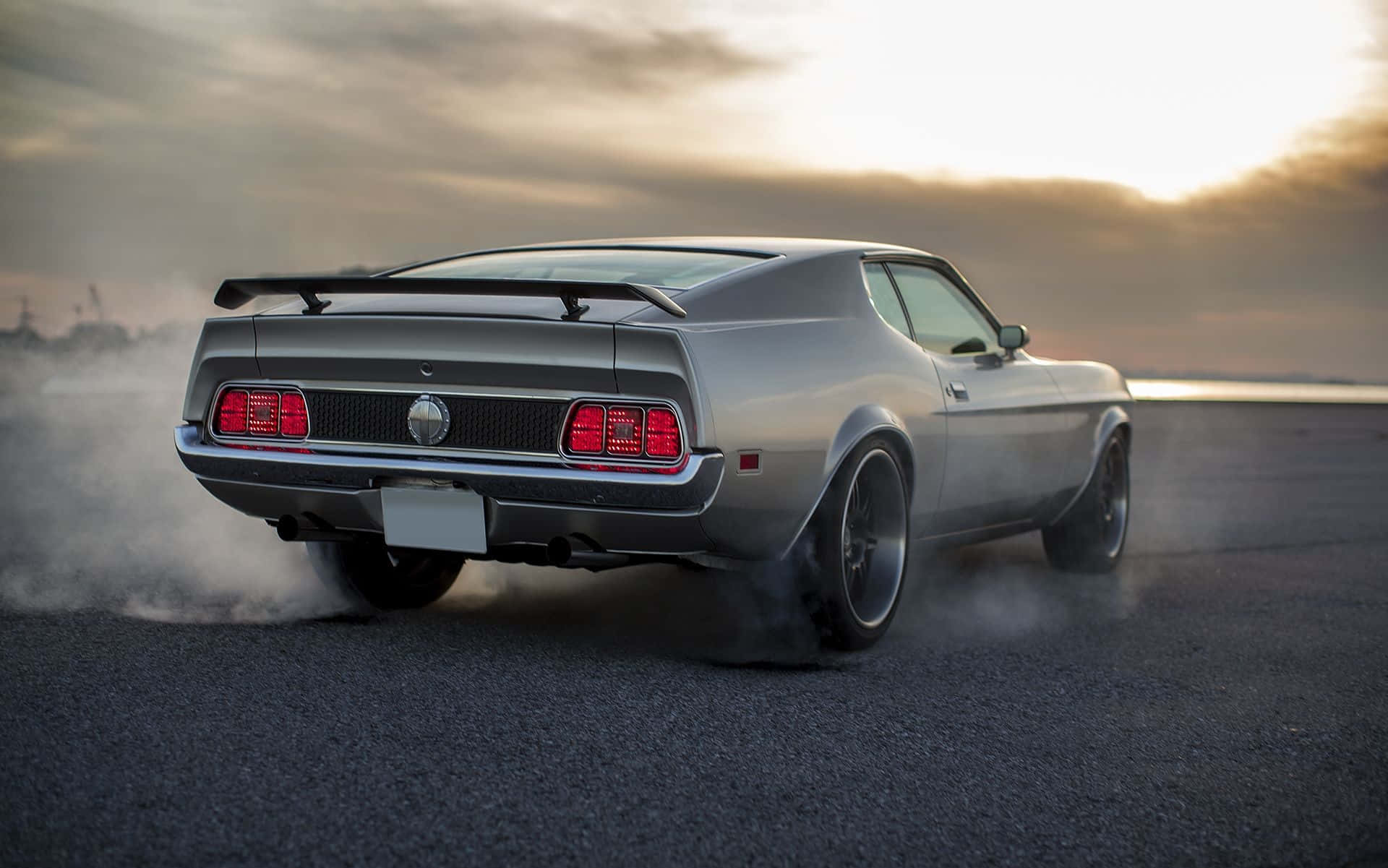 Sleek Ford Mustang Mach 1 in action on the open road. Wallpaper