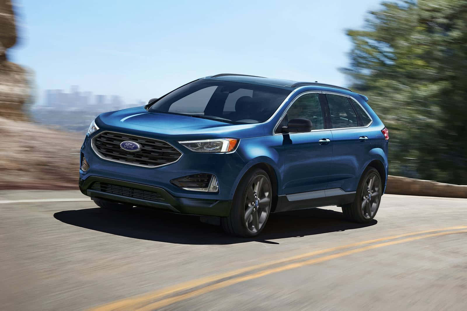 The 2020 Ford Edge Is Driving Down A Mountain Road