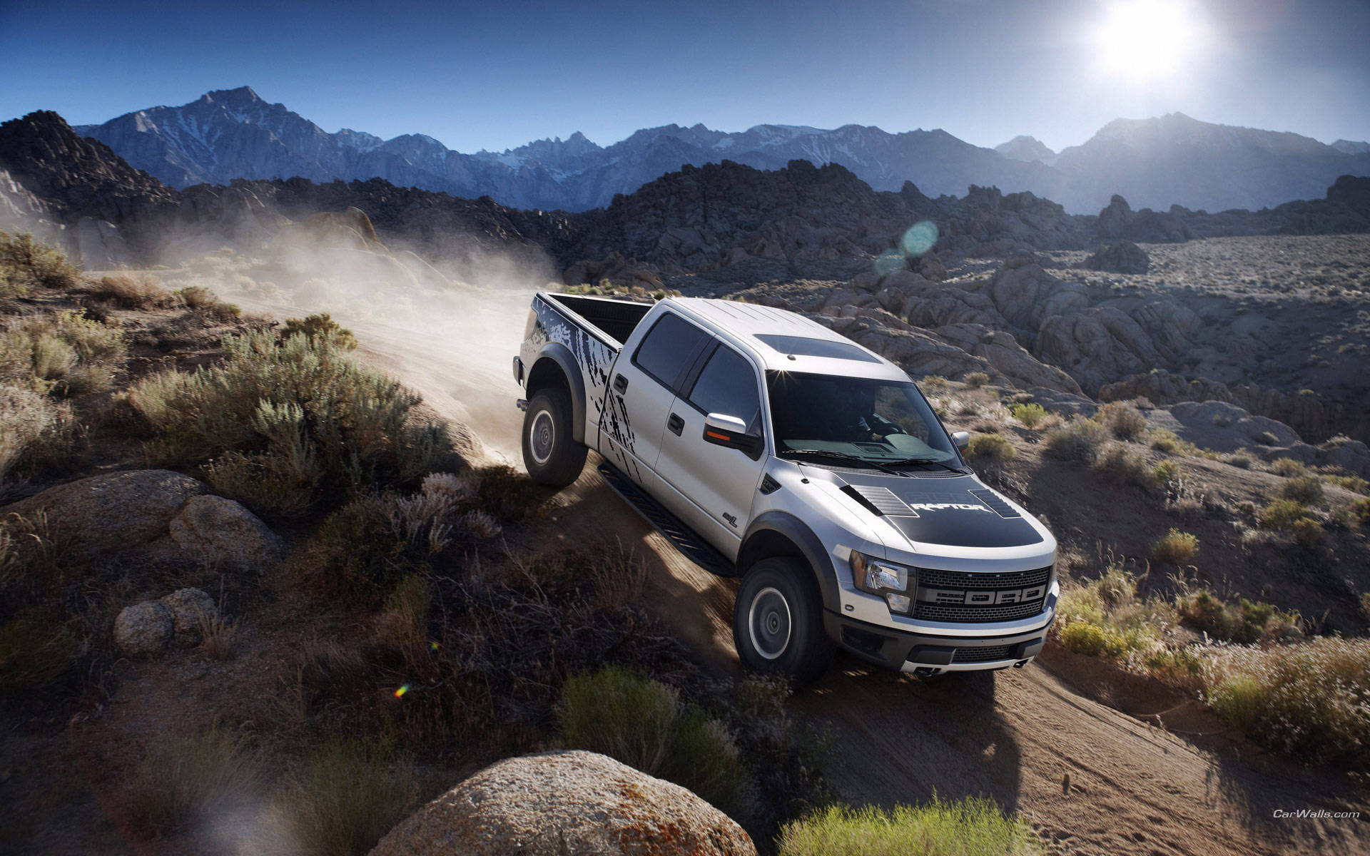 Ford Raptor Descending From Mountain Background
