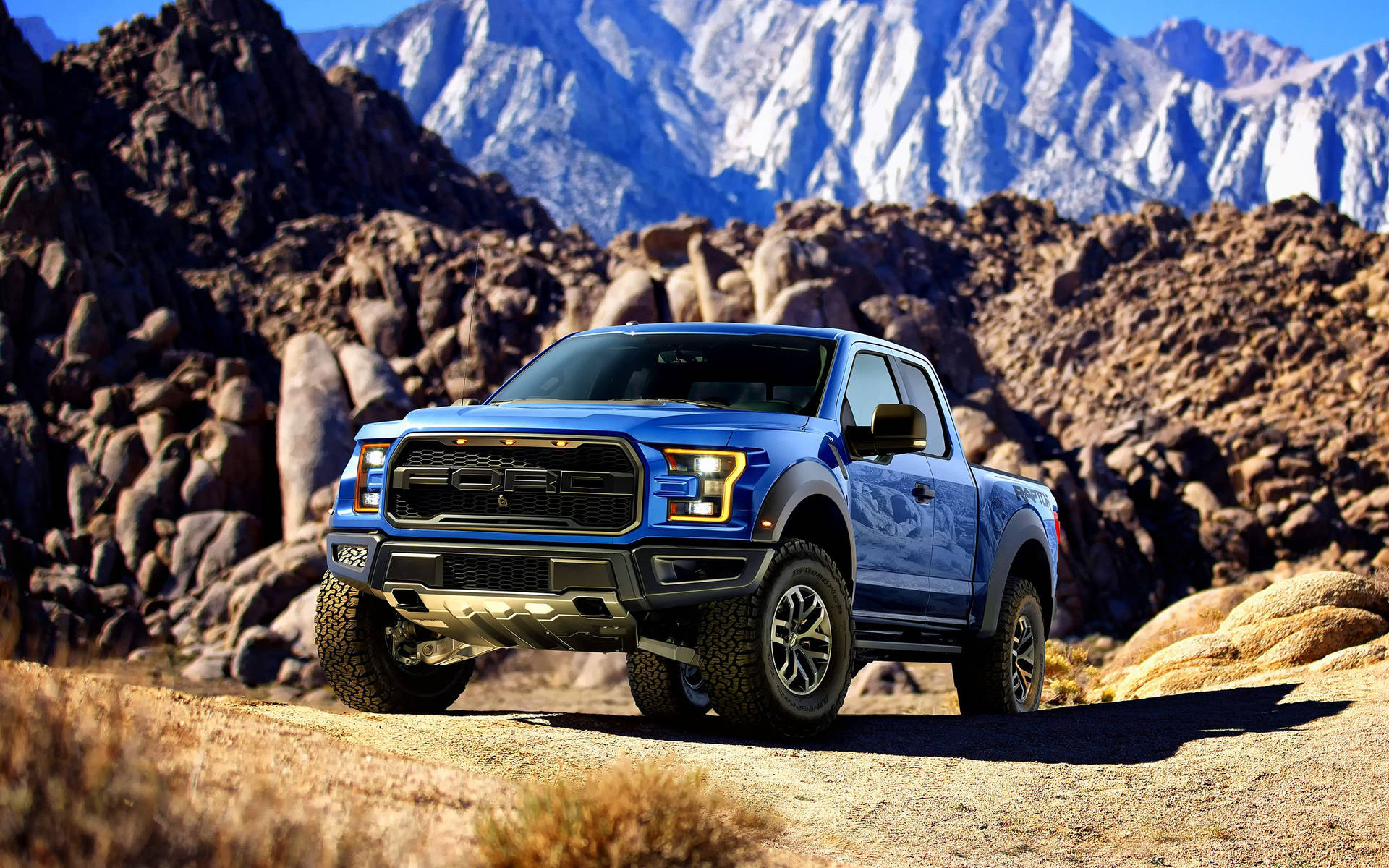 Ford Raptor On Mountain Terrain Background