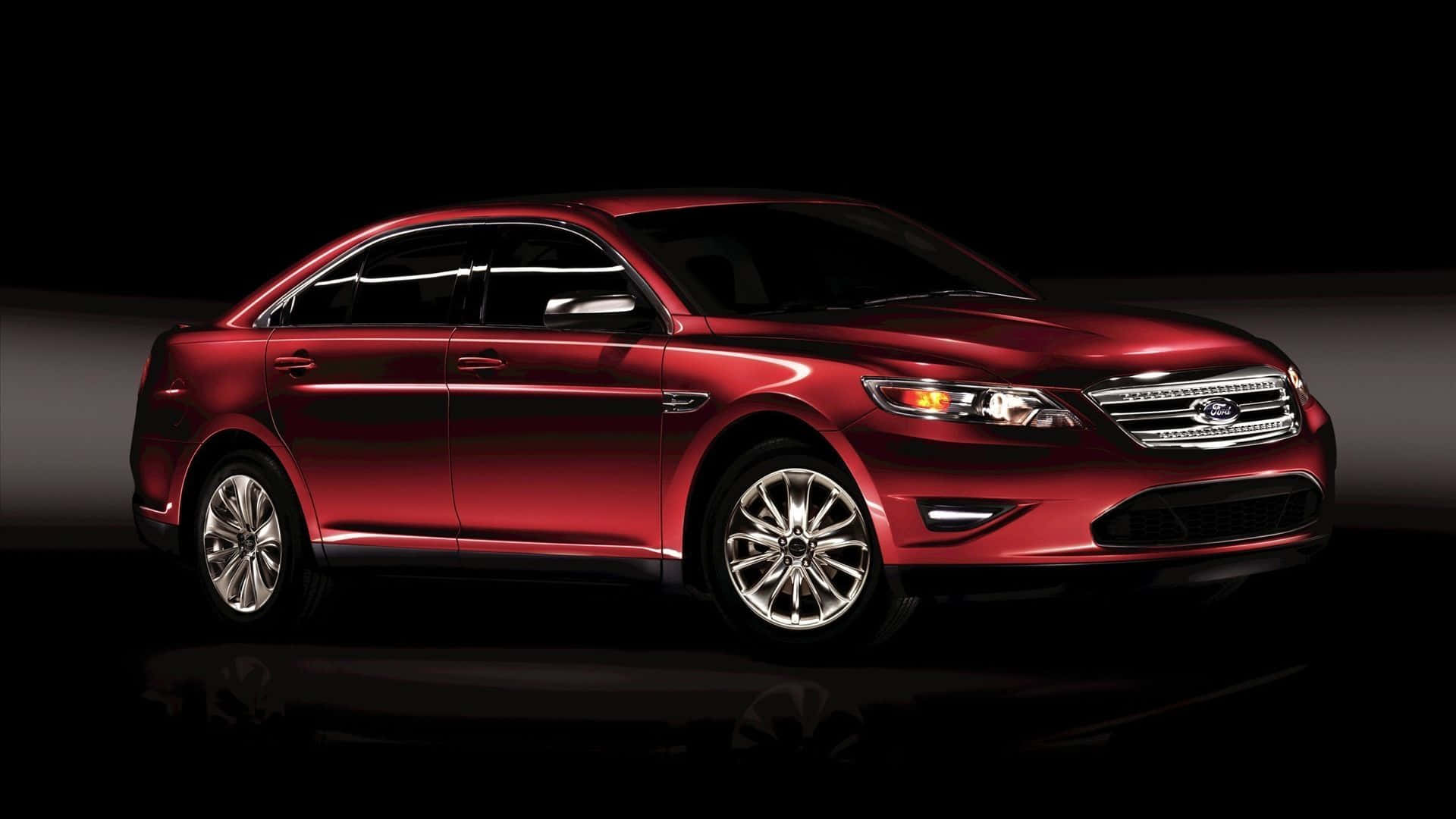 Sleek Ford Taurus Cruising Down the Highway Wallpaper