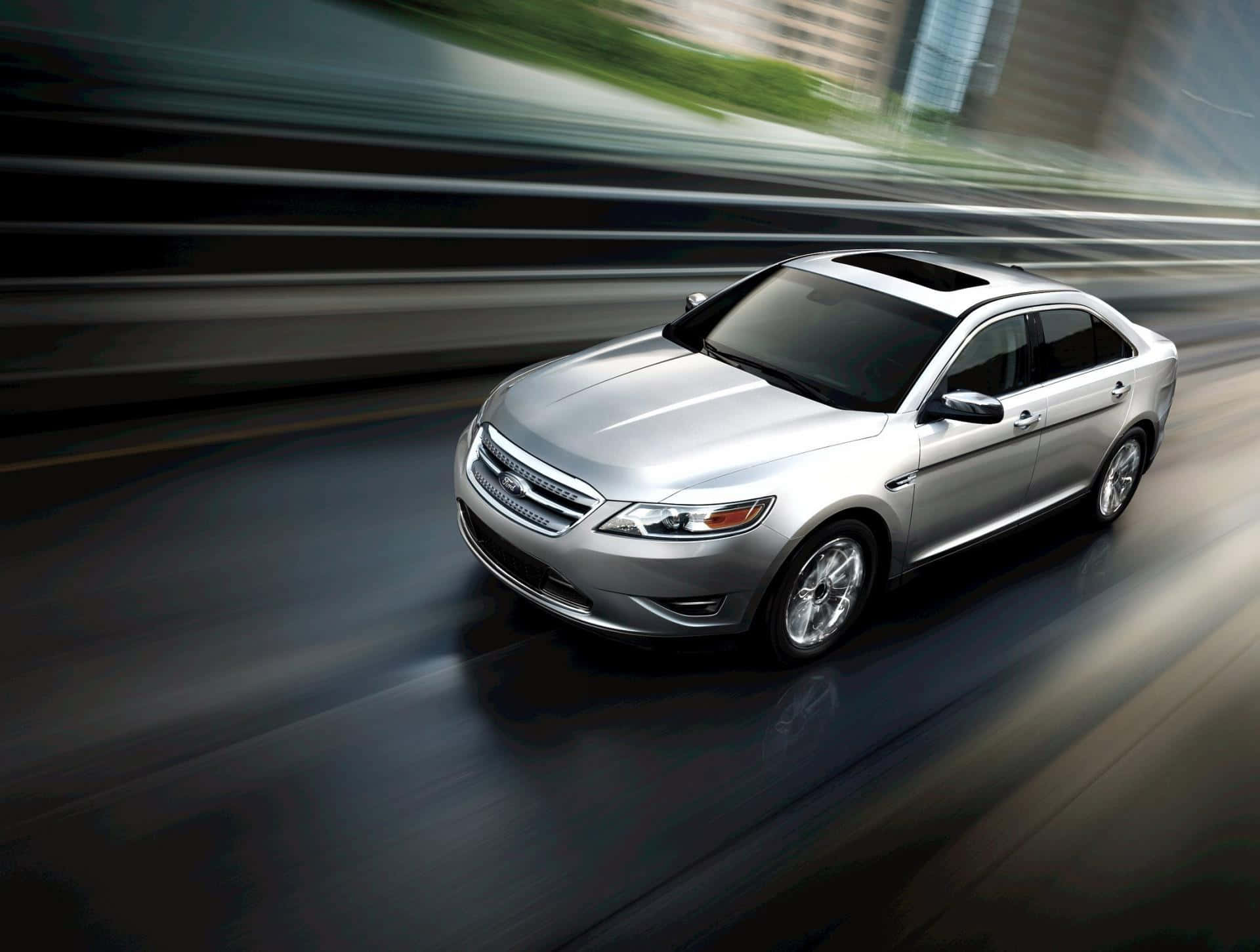 Sleek Ford Taurus in a Vibrant Setting Wallpaper