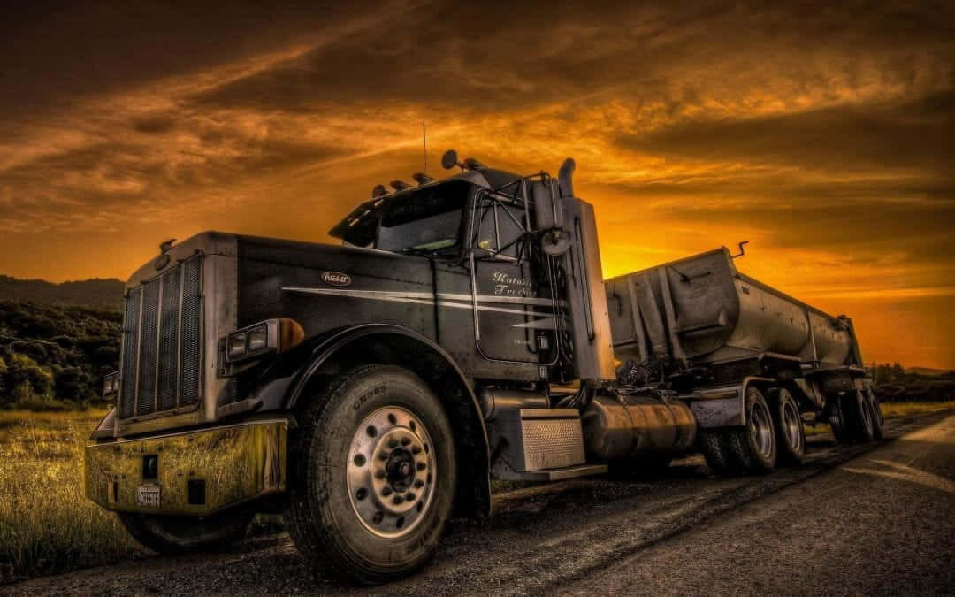A Large Truck Driving Down The Road Wallpaper