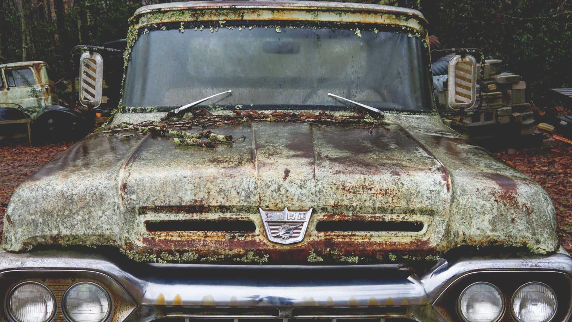 A Rusty Truck Parked In The Woods Wallpaper