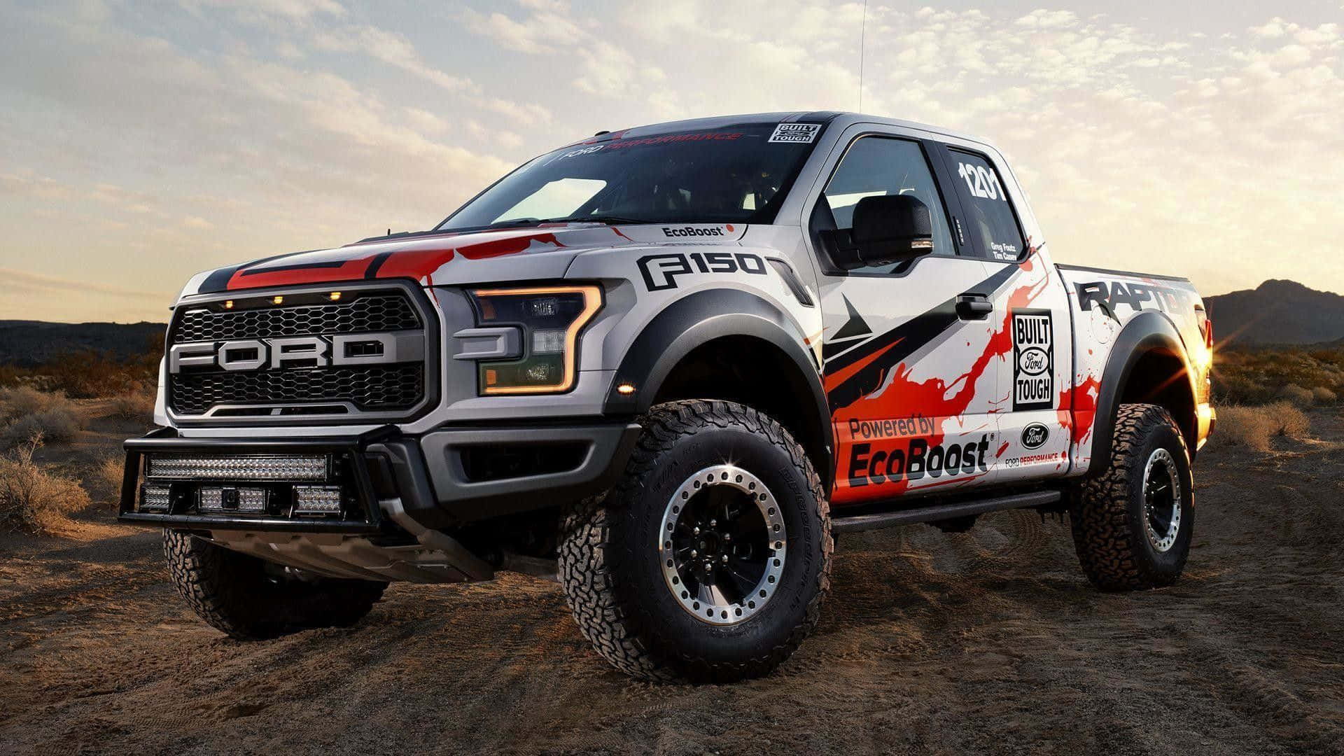 The Ford F - 150 Rpc Is Driving On A Dirt Road Wallpaper