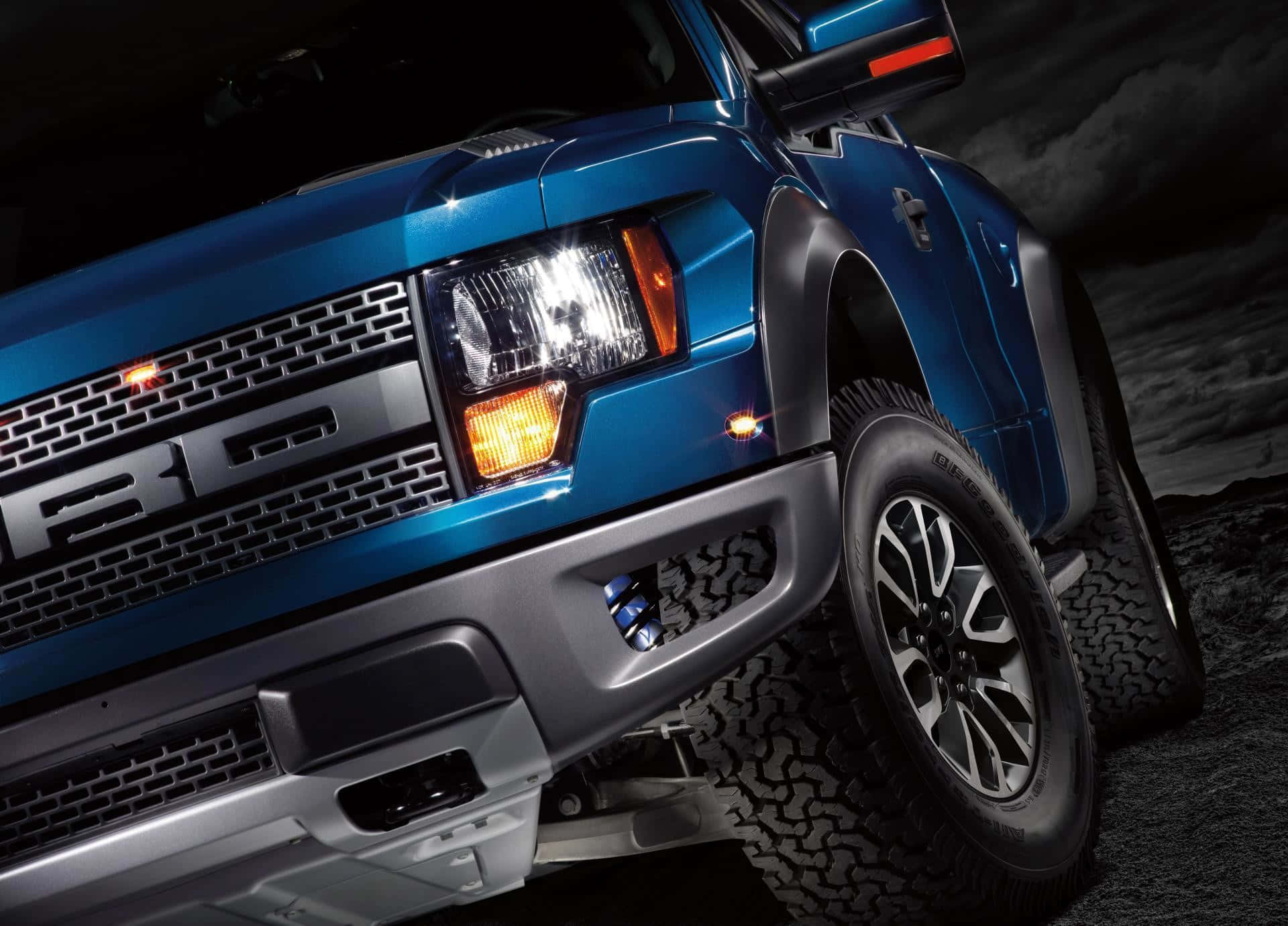 The Front End Of A Blue Ford F - 150 Truck Wallpaper