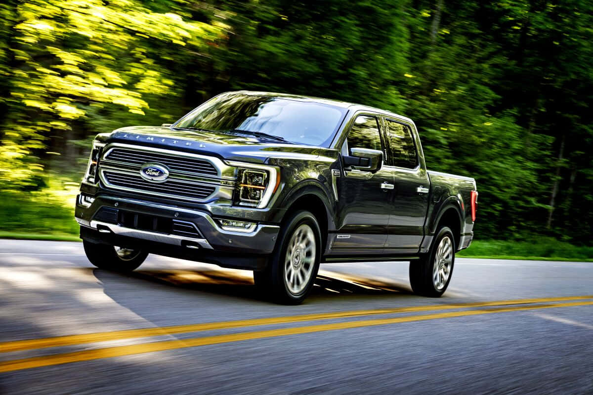 The 2020 Ford F-150 Is Driving Down A Road