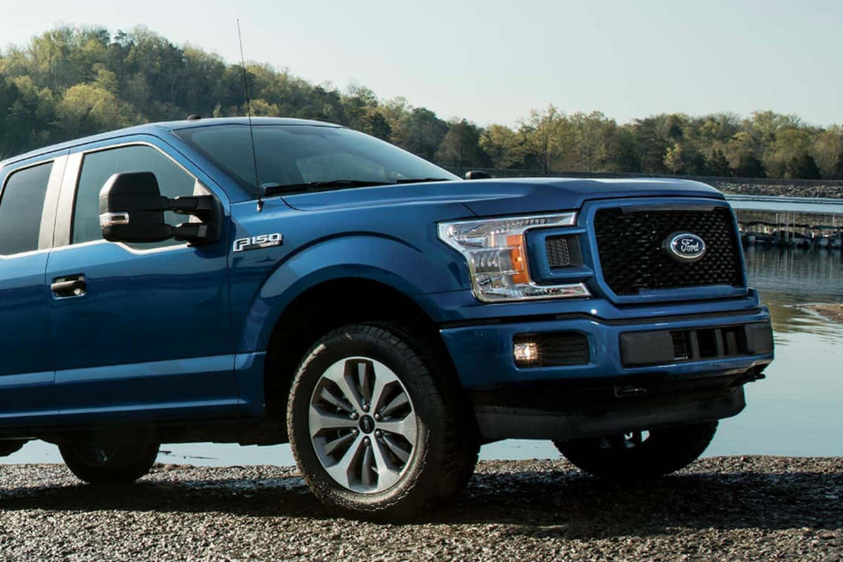 The Blue 2019 Ford F - 150 Is Parked Near A Lake