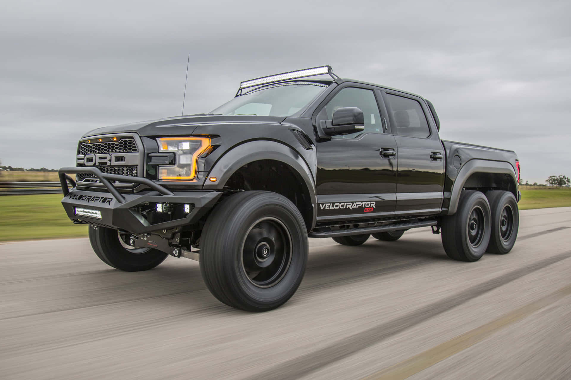 The Ford F - 150 Is Driving Down The Road