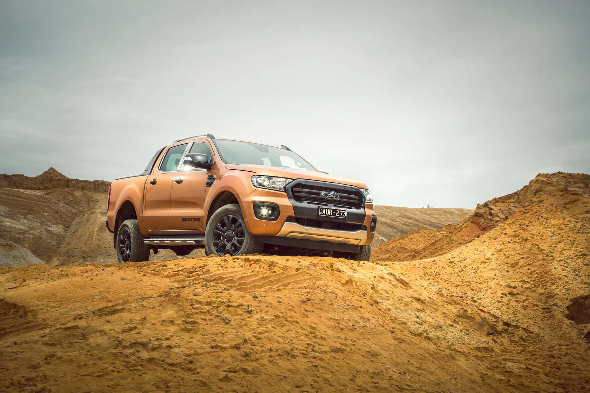 The Ford Ranger Xlt Is Parked On A Dirt Road