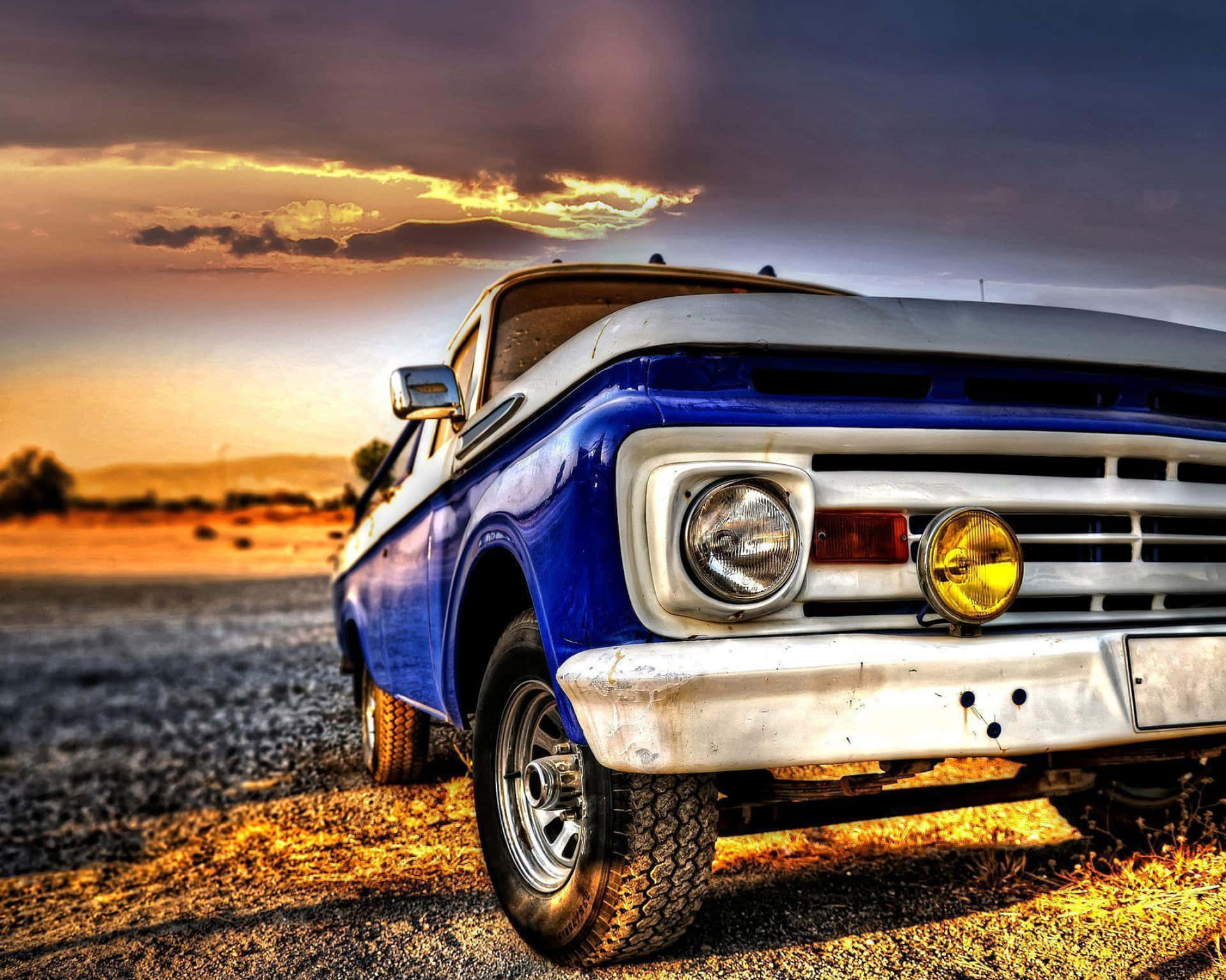 Download A Blue Truck Parked In The Dirt Wallpaper | Wallpapers.com