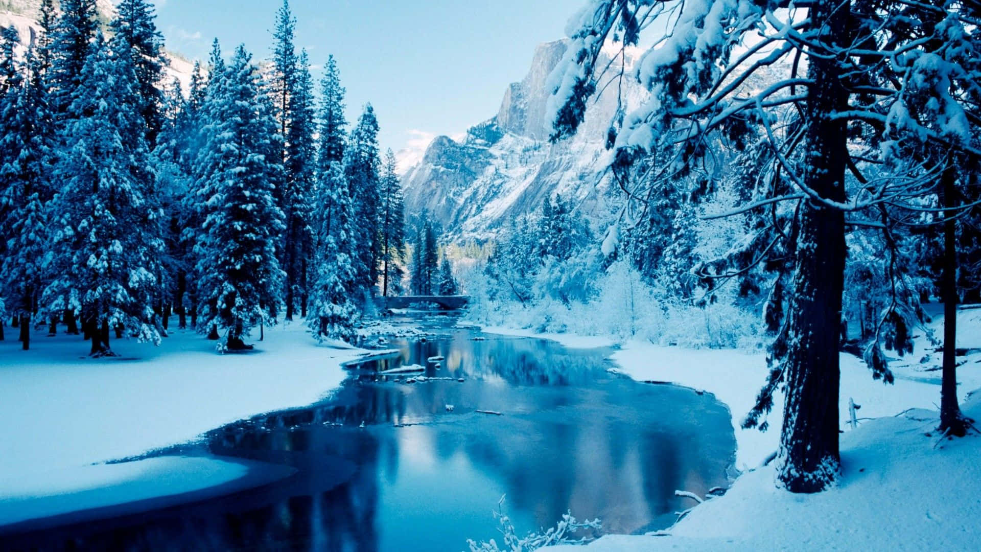 a river is covered in snow and trees
