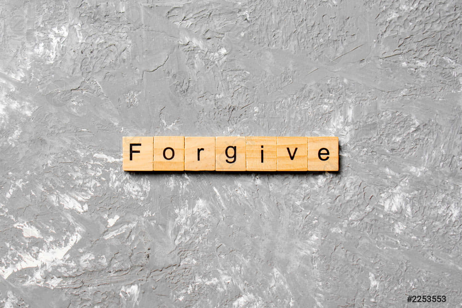 A Wooden Word Scrabble With The Word Forgive On It