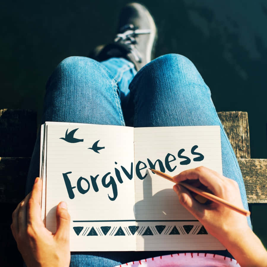 Forgiveness - Person Writing In A Notebook