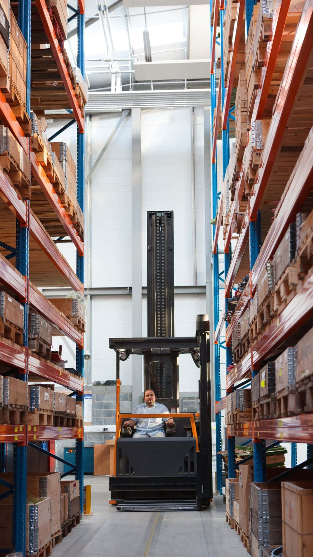 Forklift Operatorin Warehouse Aisle Wallpaper