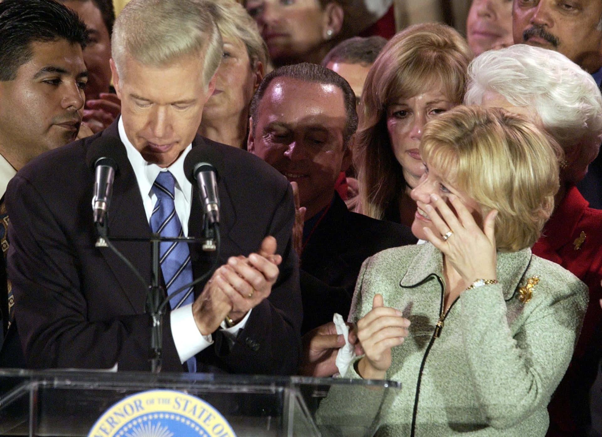 Former Governor Gray Davis Delivering A Speech At The Podium Wallpaper