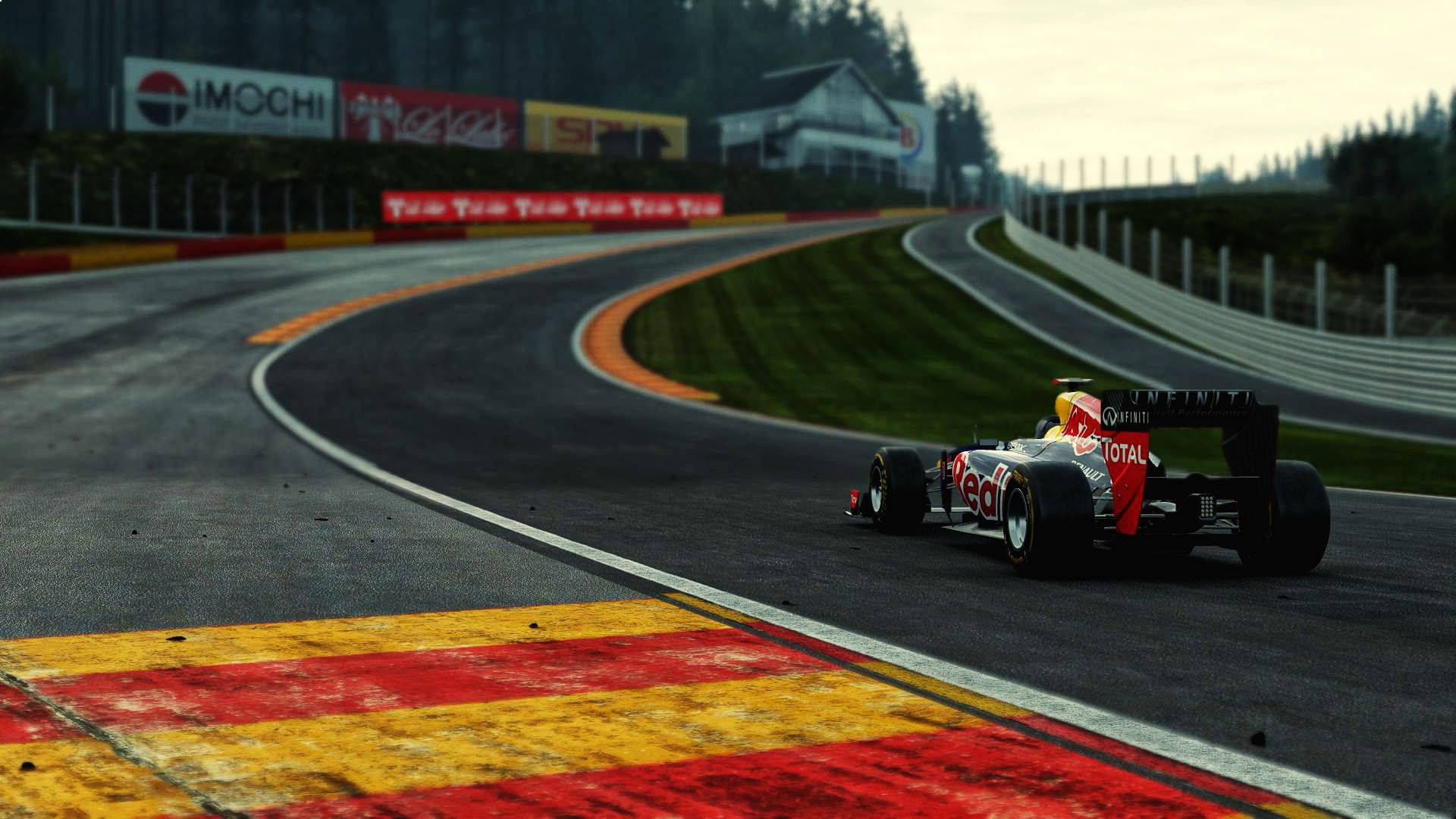 A Red Bull Racing Car Driving Down A Track Wallpaper