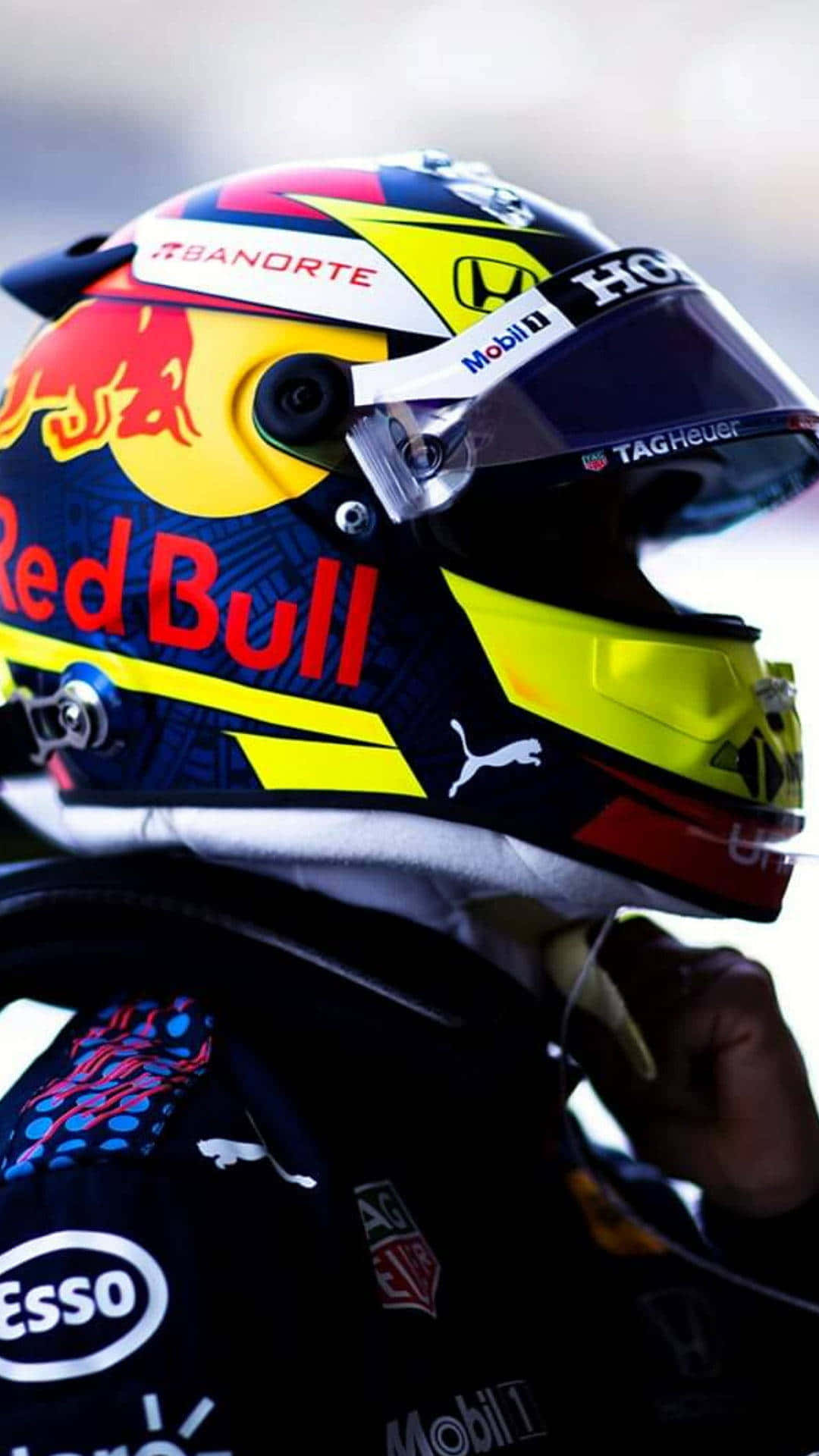 a red bull racing driver is wearing a helmet Wallpaper